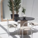 Cynthia Black Marquina Marble Dining Table with Travertine Base